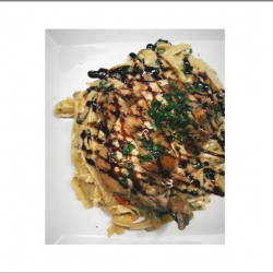 Tuscan Chicken Over Fettuccini Pasta